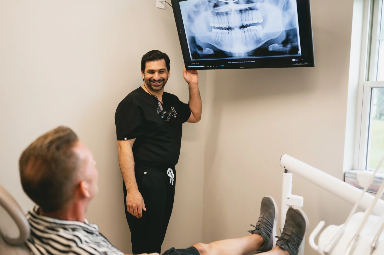 Dr. B consulting a patient in the dental chair.